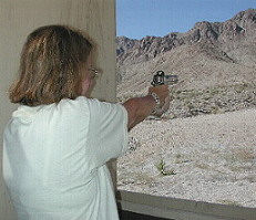 Alice with a 1911 Browning clone; photo by WEB IV